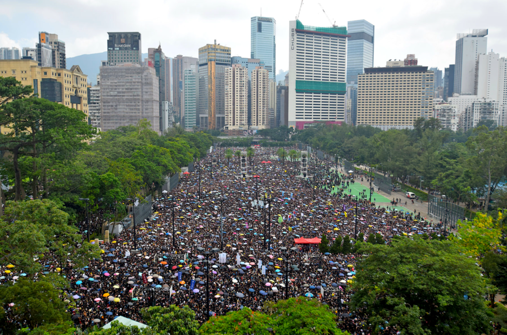 A crowd of people in a parkDescription automatically generated with low confidence