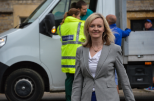 A person standing in front of a truckDescription automatically generated with medium confidence