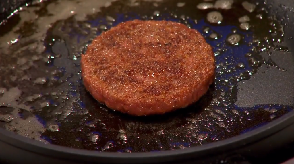 A hamburger patty on a panDescription automatically generated