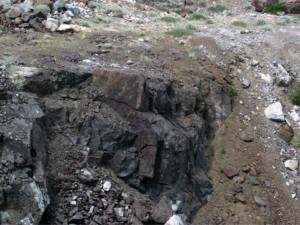 A rocky area with a crack in the groundDescription automatically generated