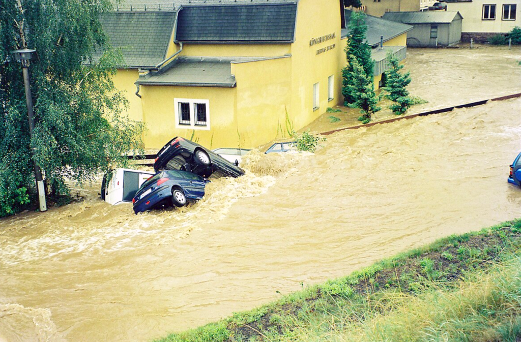 Cars in a flooded streetDescription automatically generated