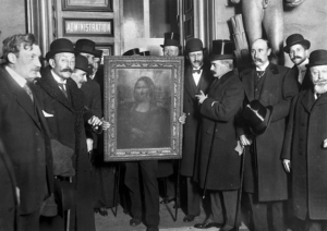 A group of men holding a paintingDescription automatically generated