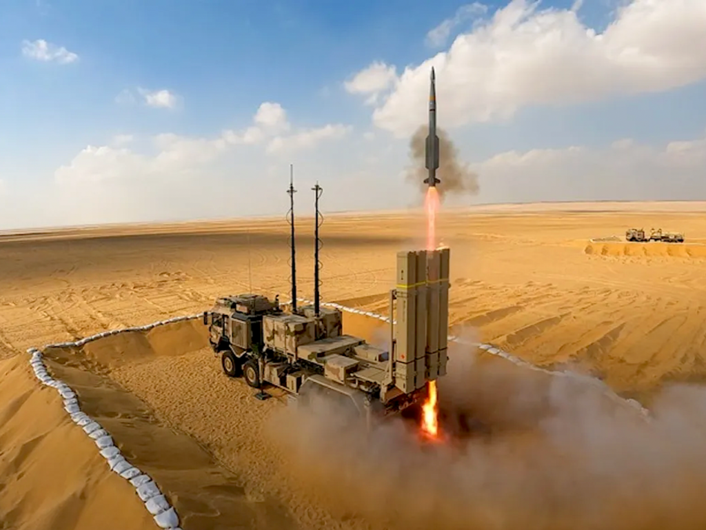 A military vehicle with a rocket in the airDescription automatically generated