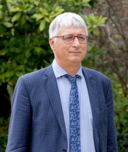 A person in a suit and tieDescription automatically generated