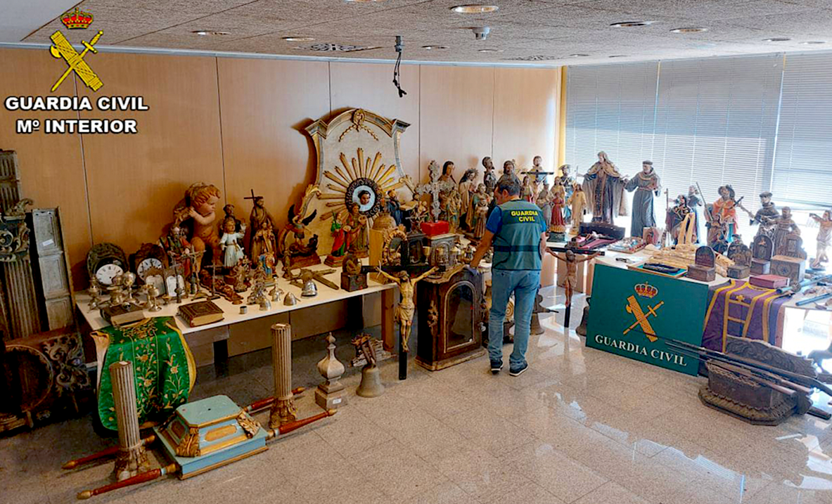 A person looking at a collection of statues

Description automatically generated