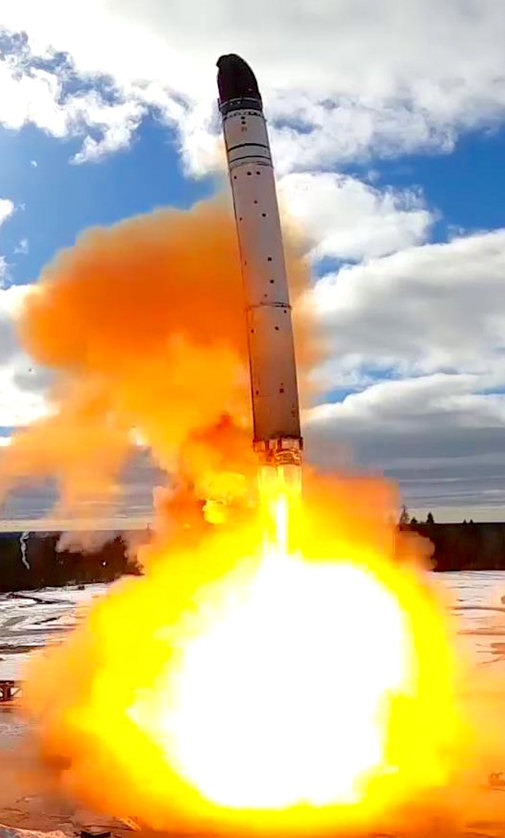 A rocket launching with orange smoke and clouds in the skyDescription automatically generated