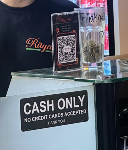 A glass with coins on it Description automatically generated