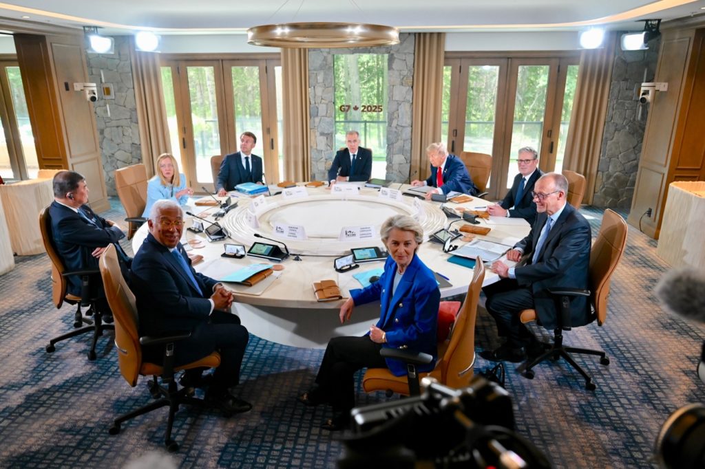 A group of people sitting around a round tableDescription automatically generated