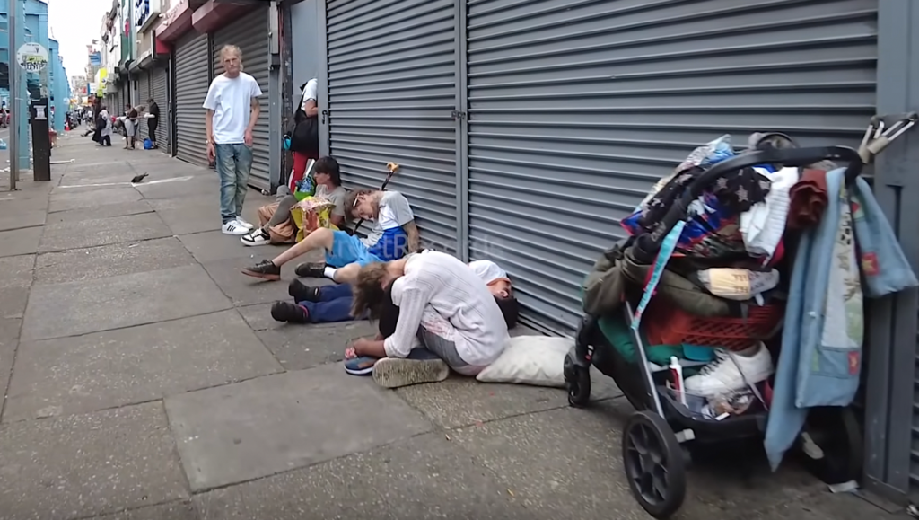 A group of people sitting on the groundDescription automatically generated