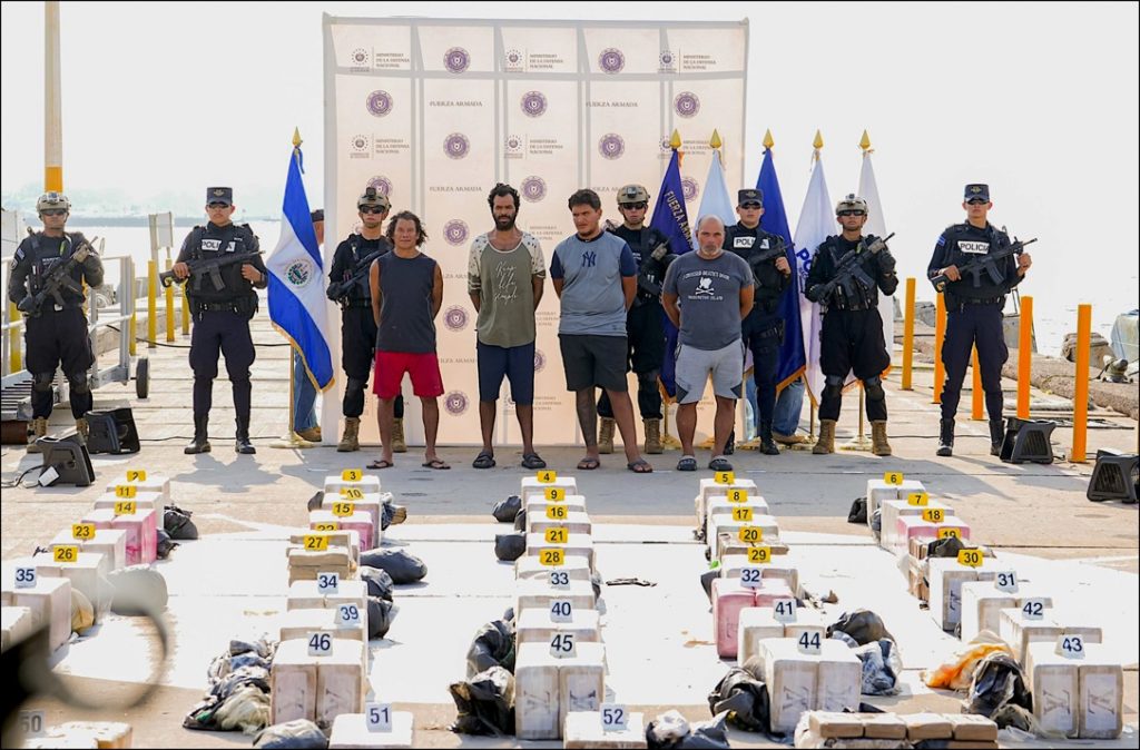 A group of people standing in front of a group of police officersDescription automatically generated
