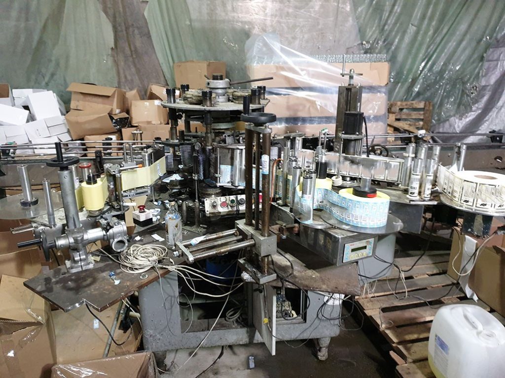 A machine in a room with palletsDescription automatically generated