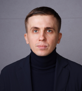 A person in a black turtleneckDescription automatically generated