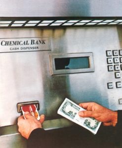 A person using a cash dispenser Description automatically generated