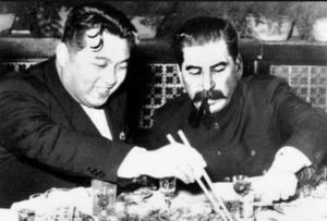A couple of men eating togetherDescription automatically generated