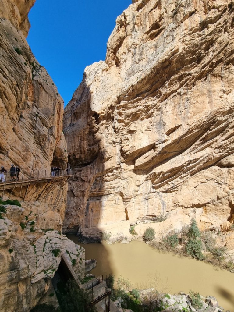 A large rock canyon with a bridge Description automatically generated with medium confidence