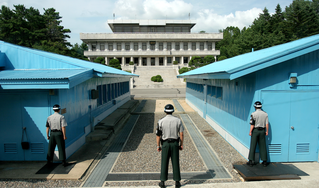A person standing in front of a buildingDescription automatically generated