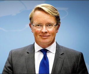 A person in a suit and tieDescription automatically generated