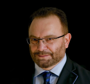 A person in a suit and tieDescription automatically generated