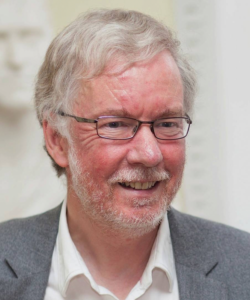 A person with glasses and a beardDescription automatically generated