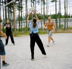 A group of people playing volleyballDescription automatically generated